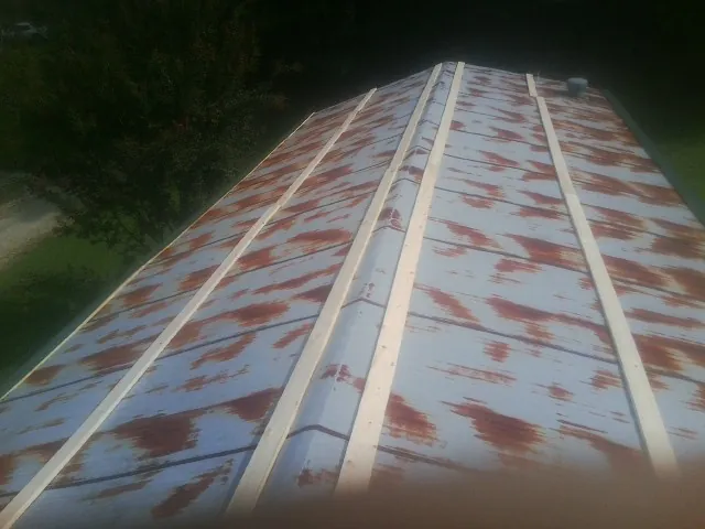 Rusted metal roof panels with new wood purlins before replacement — Storm Damage Roof Repair in Lehi by Roofing Brothers